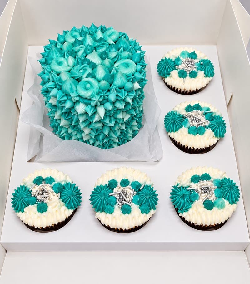 A Bento Box: a 4-inch cake and five cupcakes, iced to match, boxed together